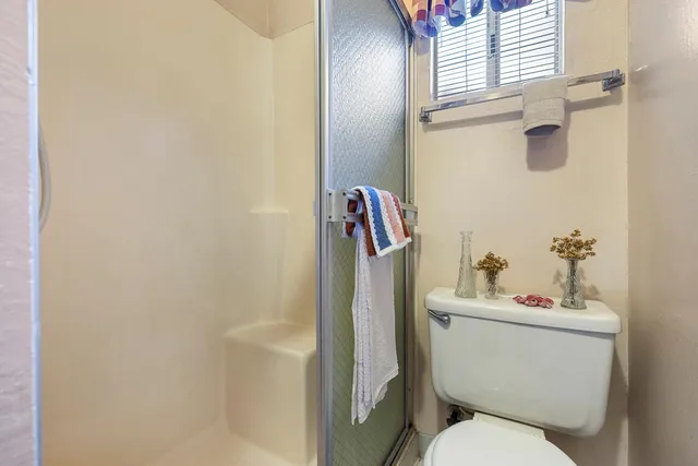 a white toilet sitting next to a bathroom sink