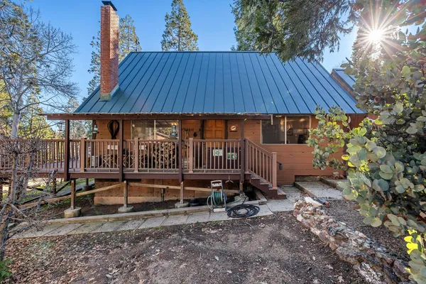 a backyard of a house with barbeque oven table and chairs