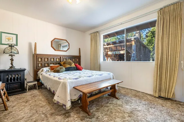 a bed sitting in a bedroom next to a window