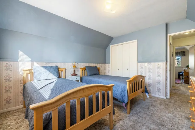 a bedroom with a bed and window