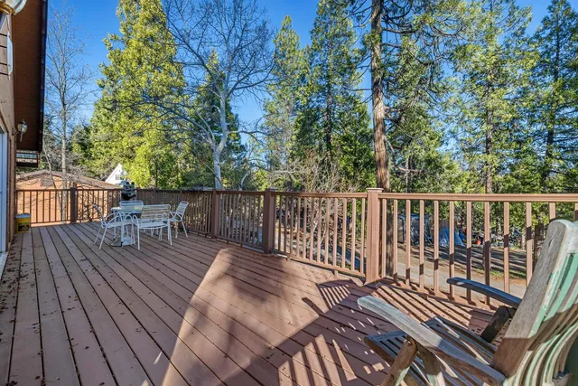 a view of balcony with wooden floor and outdoor seating