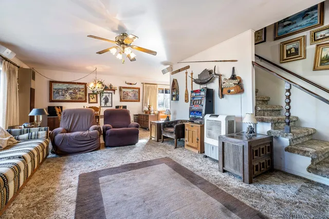 a living room with furniture and a chandelier