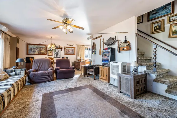 a living room with furniture and a chandelier