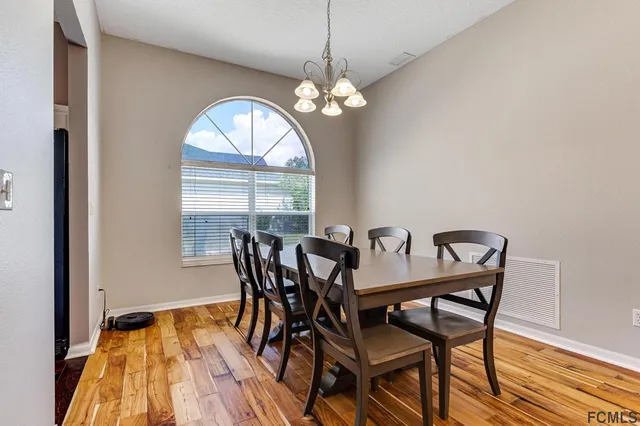 a view of a dining room with furniture and a chandelier