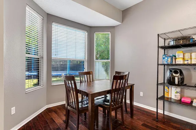 a view of a dining room with furniture and a window