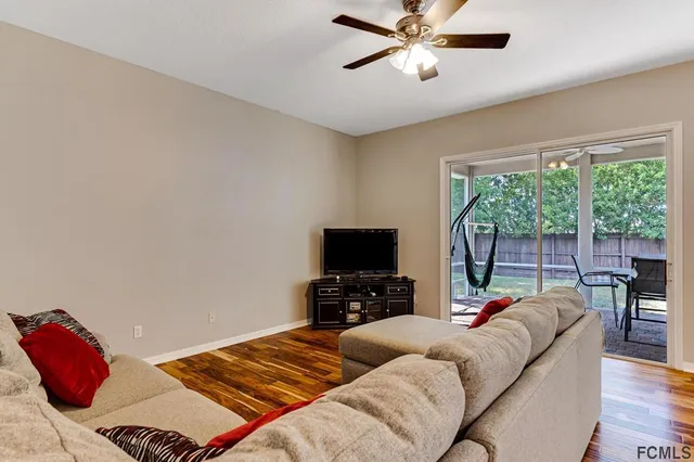 a bedroom with furniture and a flat screen tv