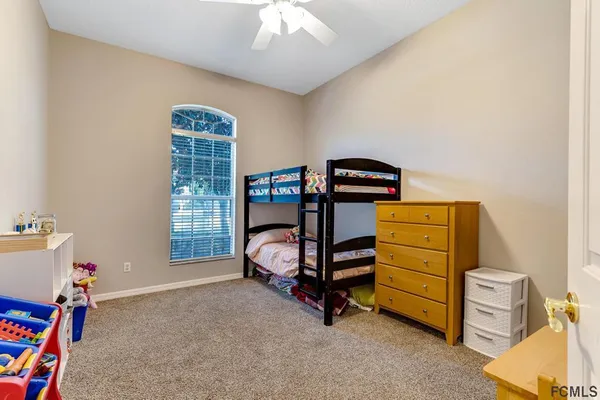 a bedroom with bunk bed and a window