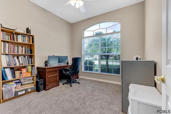 an empty room with bookshelf and a window