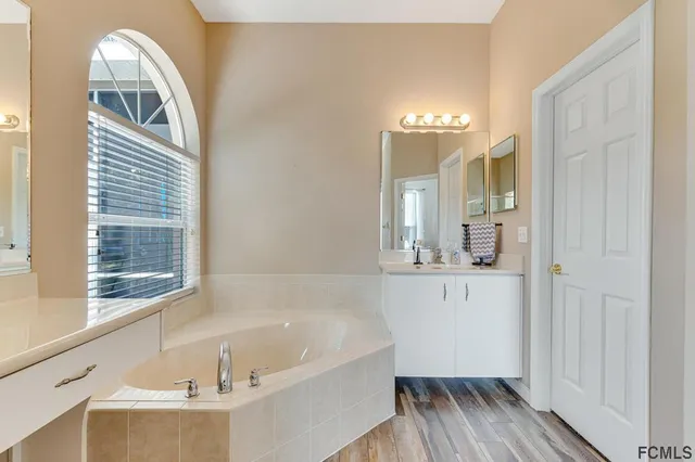 a large bathroom with a glass door shower and sink