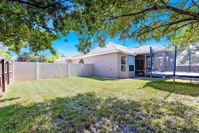 a front view of a house with a garden and trees
