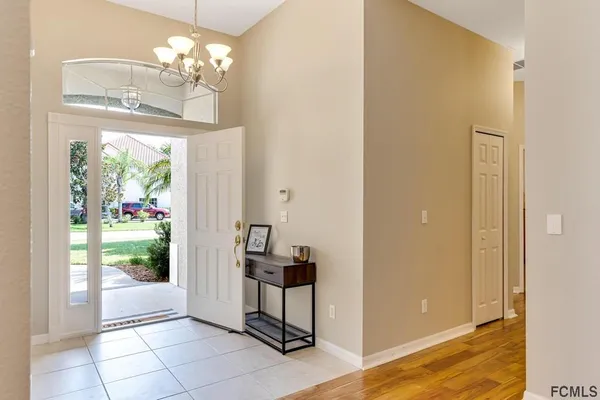 a view of a bedroom with windows and entryway