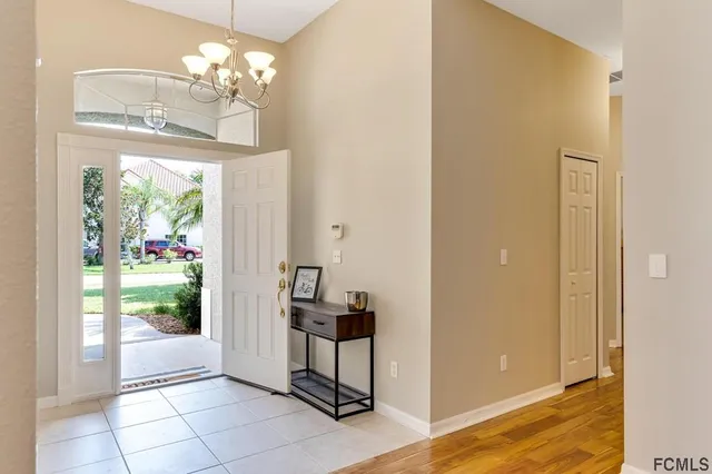 a view of a bedroom with windows and entryway