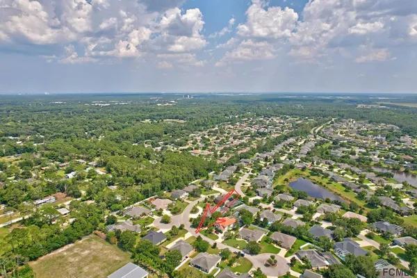 a view of a city with lush green forest