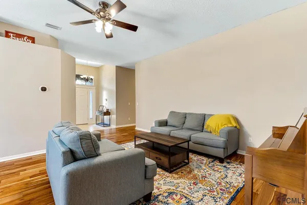 a living room with furniture and a rug