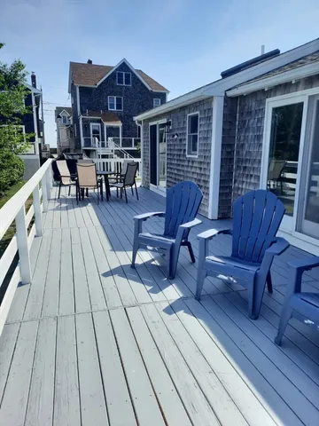 a view of a wooden chairs on the deck