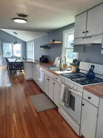 a kitchen with a stove a sink and a refrigerator