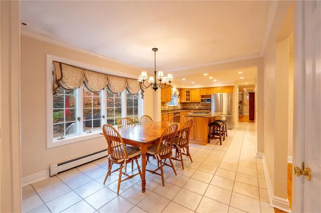 a view of a dining room with furniture and chandelier