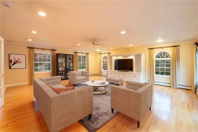 a living room with furniture wooden floor and a flat screen tv