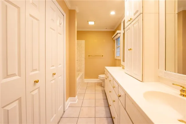 a bathroom with a granite countertop sink a toilet and shower