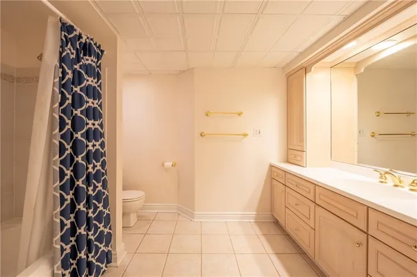 a bathroom with a sink a toilet and a shower