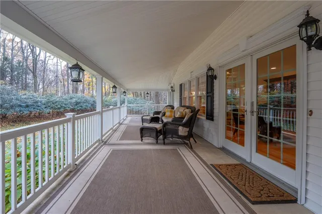 a balcony with furniture and a gate
