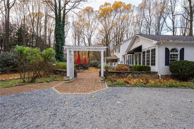 a front view of house with yard and green space