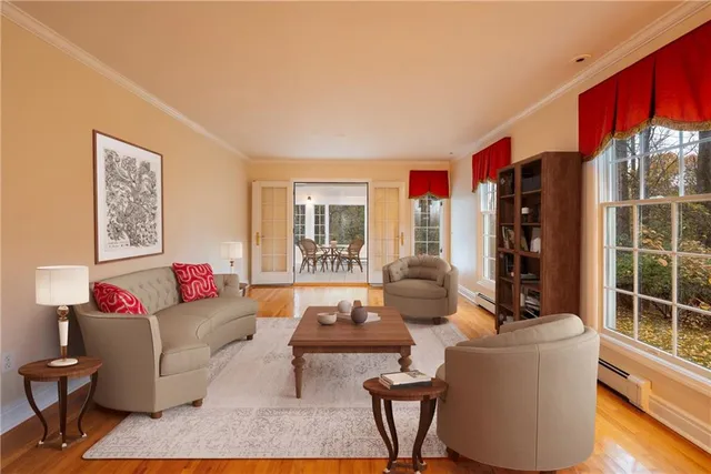 a living room with furniture and a floor to ceiling window