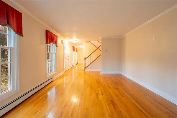 a view of an entryway with wooden floor