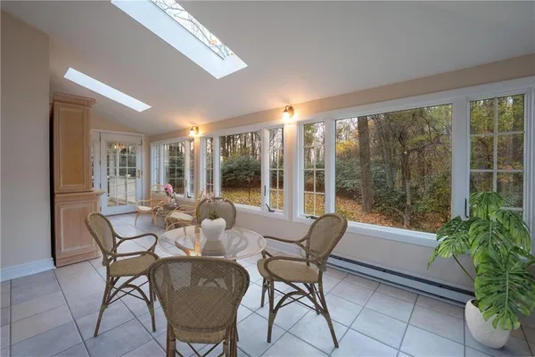 a dining room with furniture and large windows