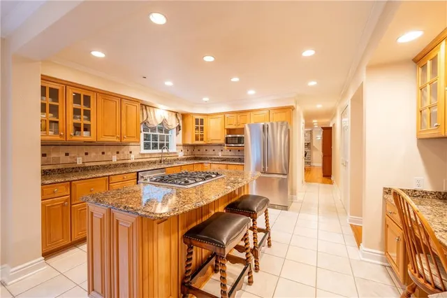 a kitchen with stainless steel appliances granite countertop a stove and a refrigerator