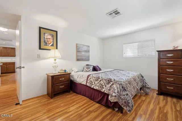 a bedroom with a bed and a dresser