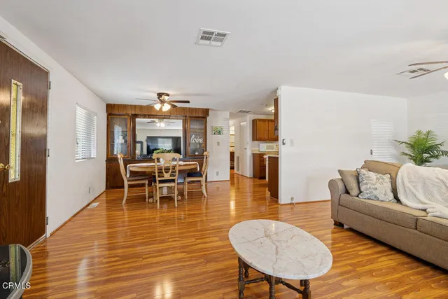 a living room with furniture and wooden floor