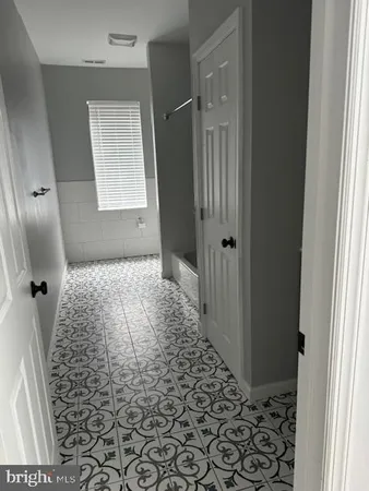 a view of hallway with wooden floor