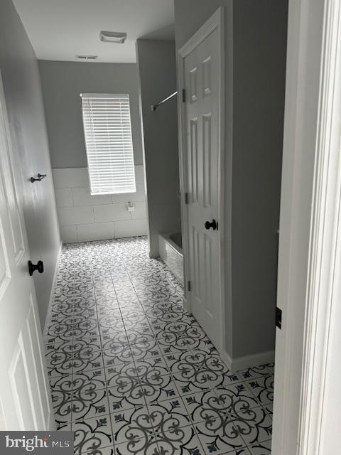 107 West Merchant Street, Unit 2B Audubon, NJ 08106 - Photo 7 of 13 a bedroom with a bed and a window