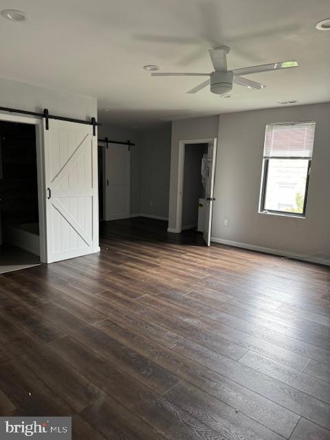 107 West Merchant Street, Unit 2B Audubon, NJ 08106 - Photo 8 of 13 an empty room with wooden floor and windows