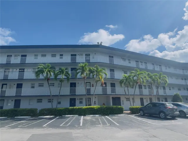 a front view of a house with plants
