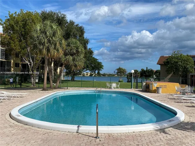 a view of a swimming pool with lawn chairs