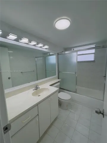 a bathroom with a double vanity sink and a toilet