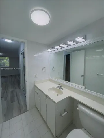 a bathroom with a sink vanity and mirror