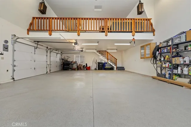 a view of a kitchen with refrigerator and wooden floor