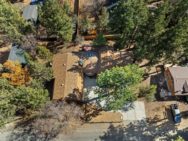 a view of a house with a tree in the yard