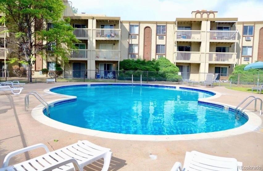 1304 South Parker Road, Unit 146 Denver, CO 80231 - Photo 14 of 22 a view of an swimming pool with outdoor seating