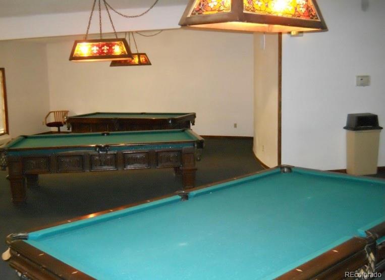 1304 South Parker Road, Unit 146 Denver, CO 80231 - Photo 20 of 22 a room with a table and a chandelier