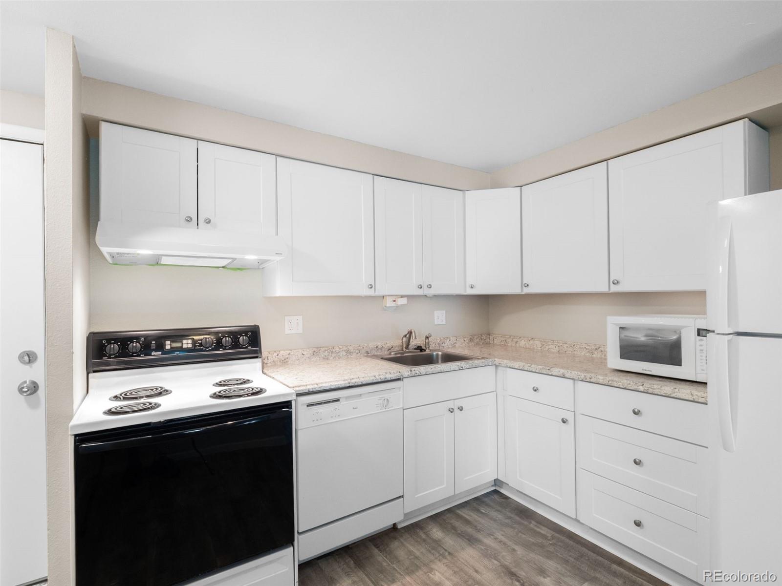 1304 South Parker Road, Unit 146 Denver, CO 80231 - Photo 2 of 22 a kitchen with cabinets appliances a sink and a stove