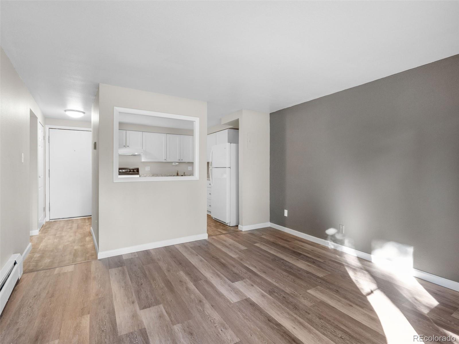 1304 South Parker Road, Unit 146 Denver, CO 80231 - Photo 6 of 22 a view of empty room with wooden floor