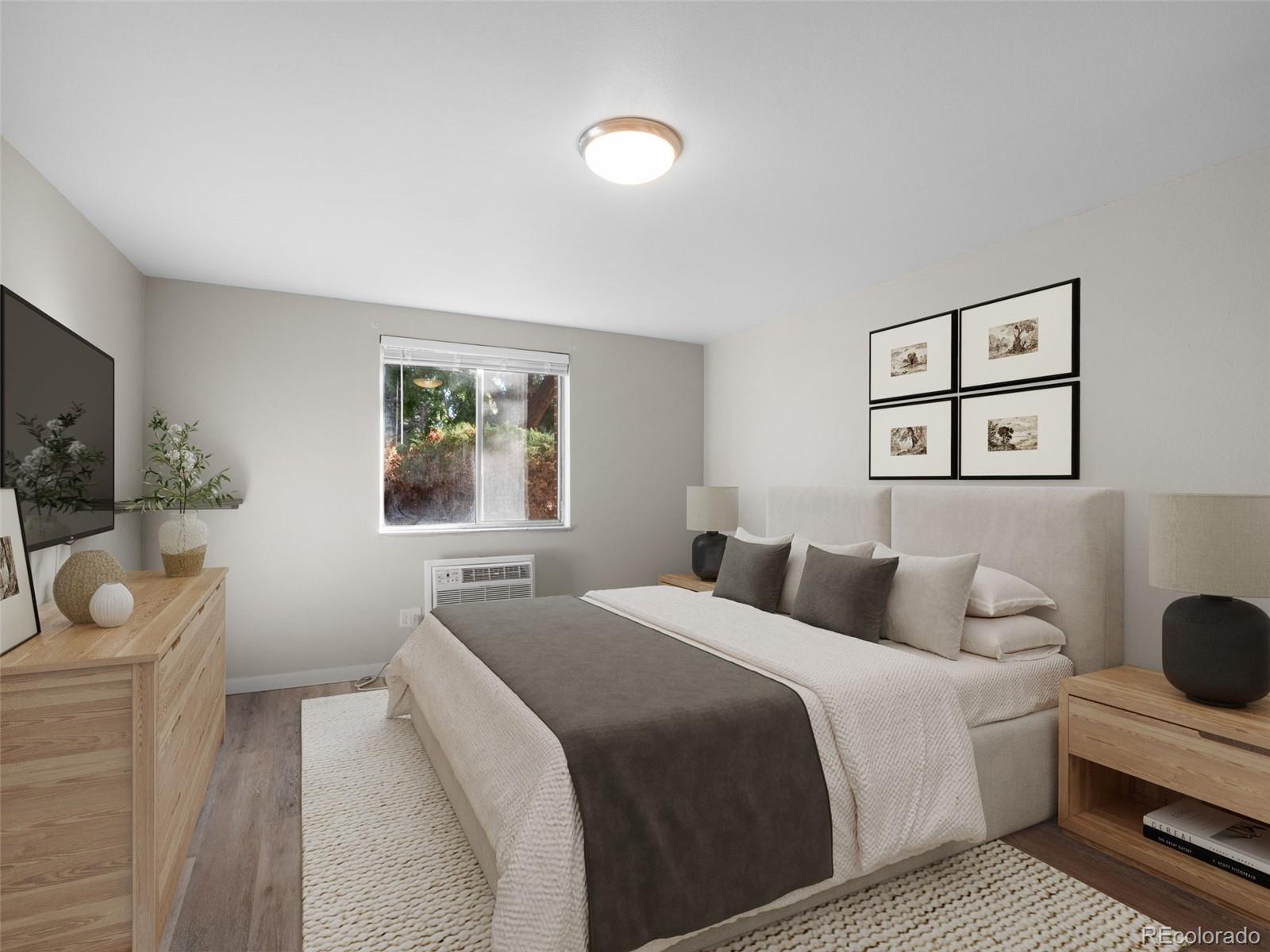 1304 South Parker Road, Unit 146 Denver, CO 80231 - Photo 7 of 22 a bedroom with a bed and a chandelier