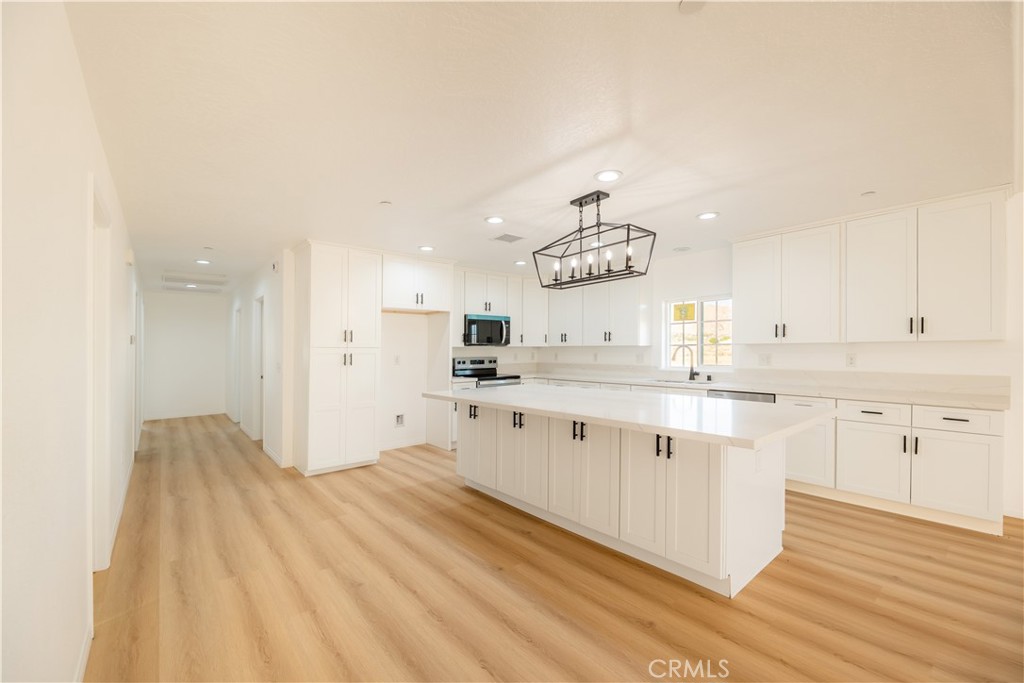 16925 Nanticoke Road Apple Valley, CA 92307 - Photo 25 of 87 a large kitchen with kitchen island a sink stainless steel appliances and cabinets