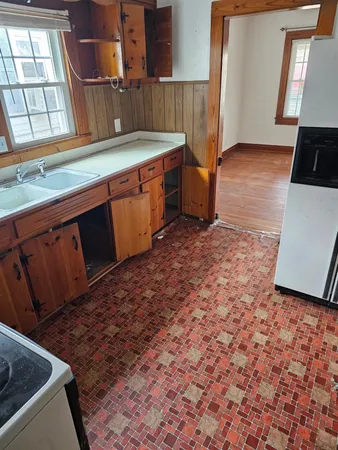 a kitchen with stainless steel appliances granite countertop a sink a stove a microwave a counter top and cabinets