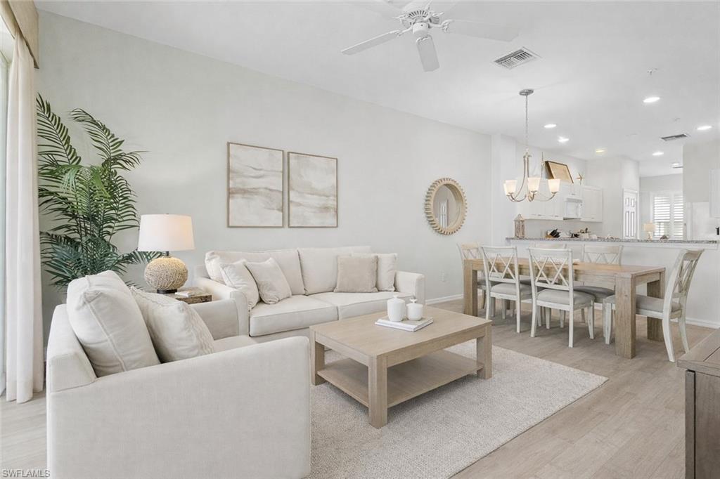 7910 Mahogany Run Lane, Unit 1225 Naples, FL 34113 - Photo 1 of 48 a living room with furniture potted plant and a window