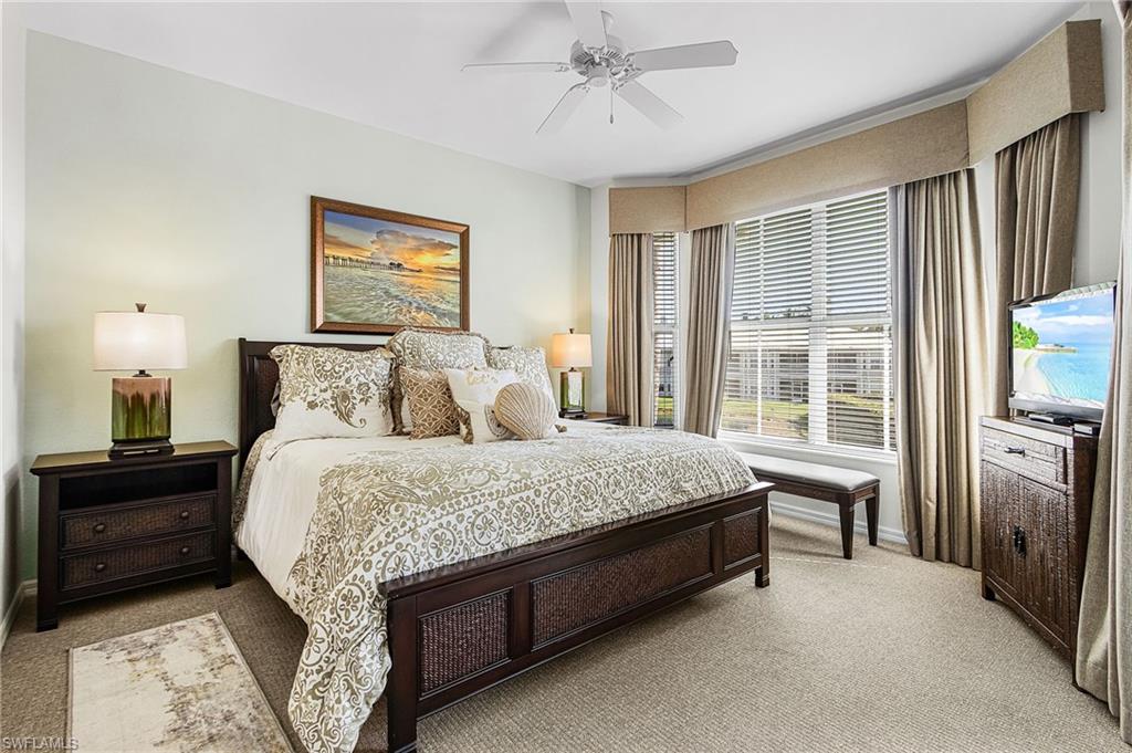 7910 Mahogany Run Lane, Unit 1225 Naples, FL 34113 - Photo 16 of 48 a bedroom with a bed dresser and a window